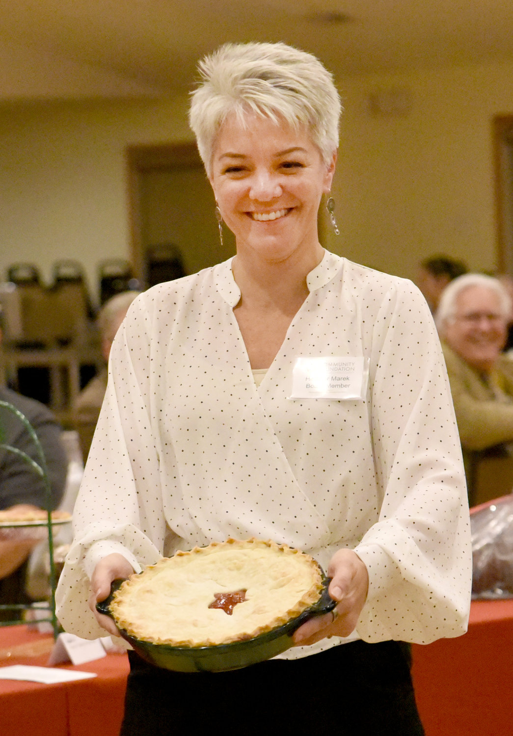 Heather Marek shows off a pie at the Washington County Community Foundation’s Chef Spotlight dinner on Nov. 4 at Holy Trinity Parish Life Center in Richmond. The desserts, auctioned off by Dwight Duwa of Duwa’s Auction Service, benefitted both the foundation and the Kalona Historical Village.